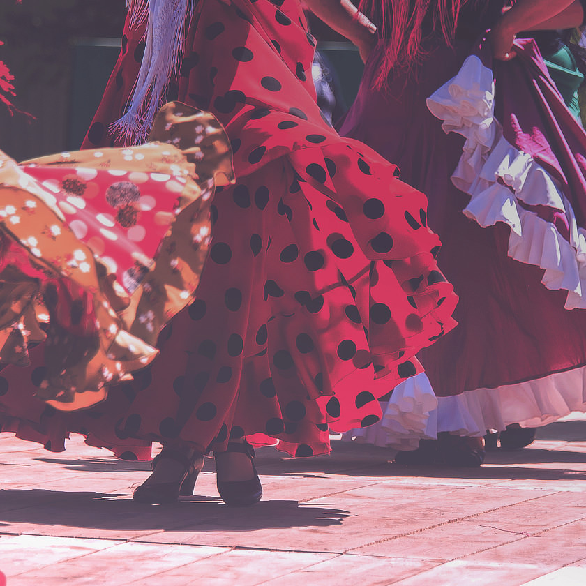 Photo: Crop of women dancing in flamenco-style dresses